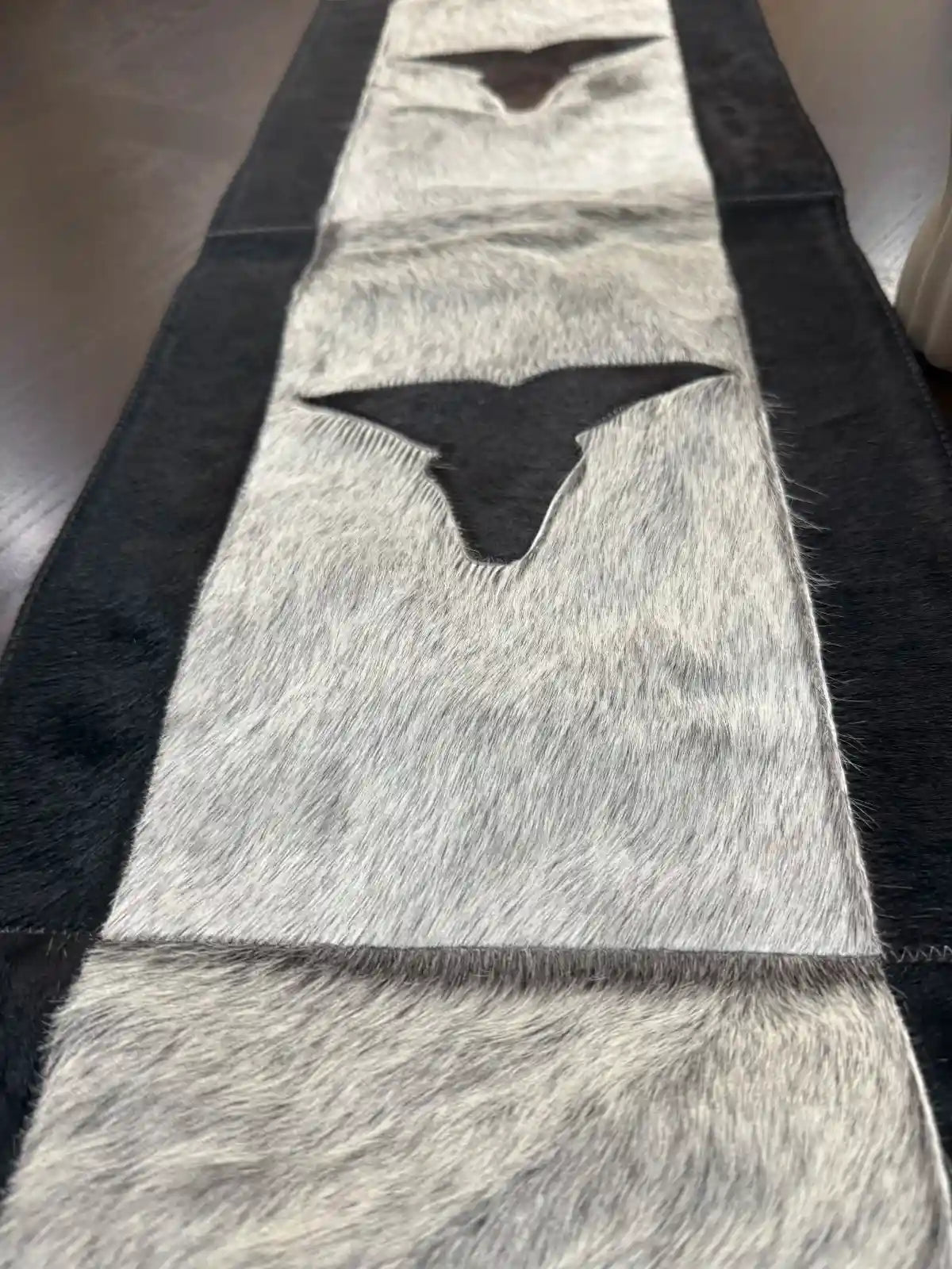 Cowhide bullhead table runner with bullhead patch, having leather fringes