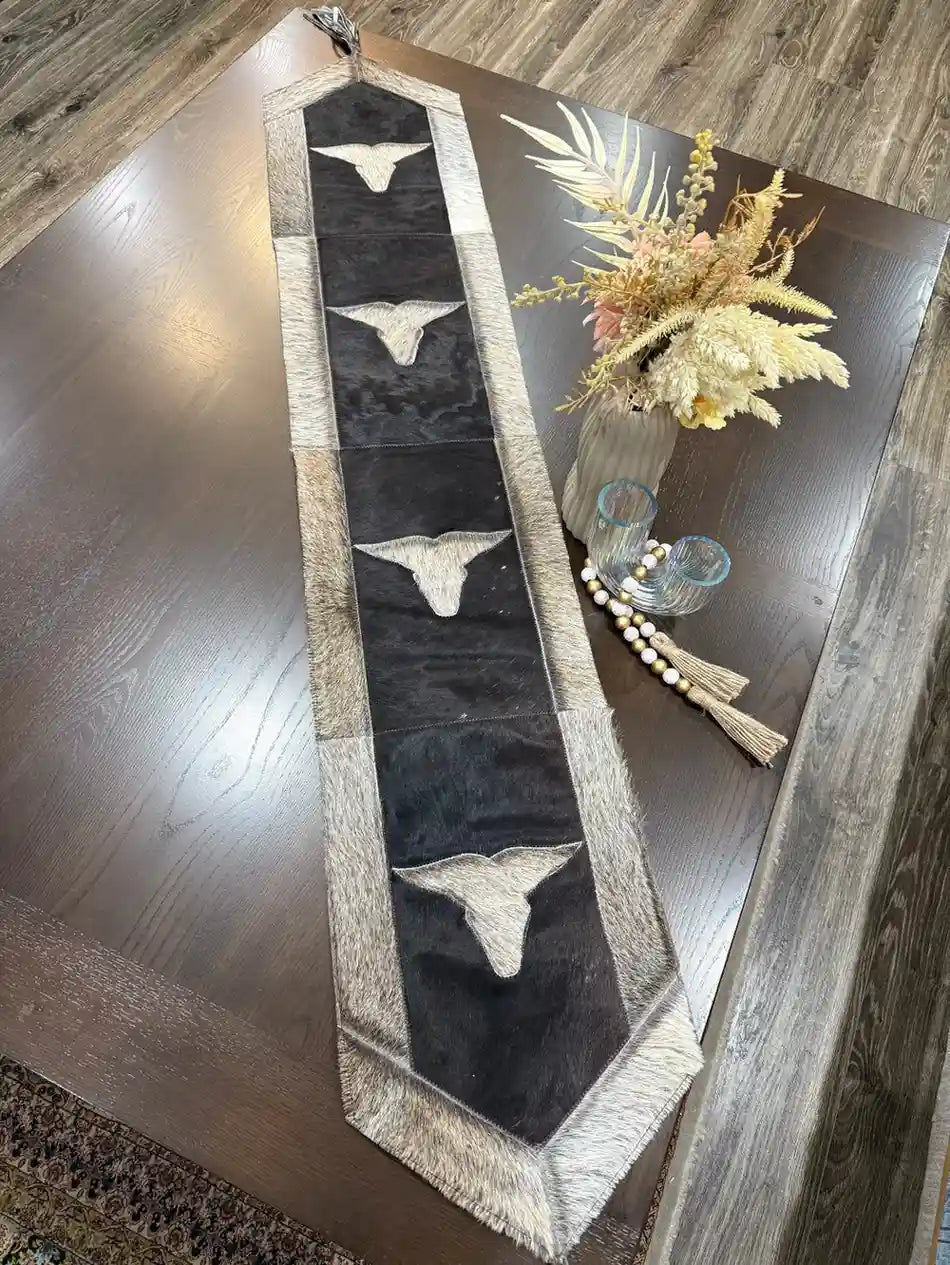 Cowhide bullhead table runner with bullhead patch, having leather fringes Leather Lovers
