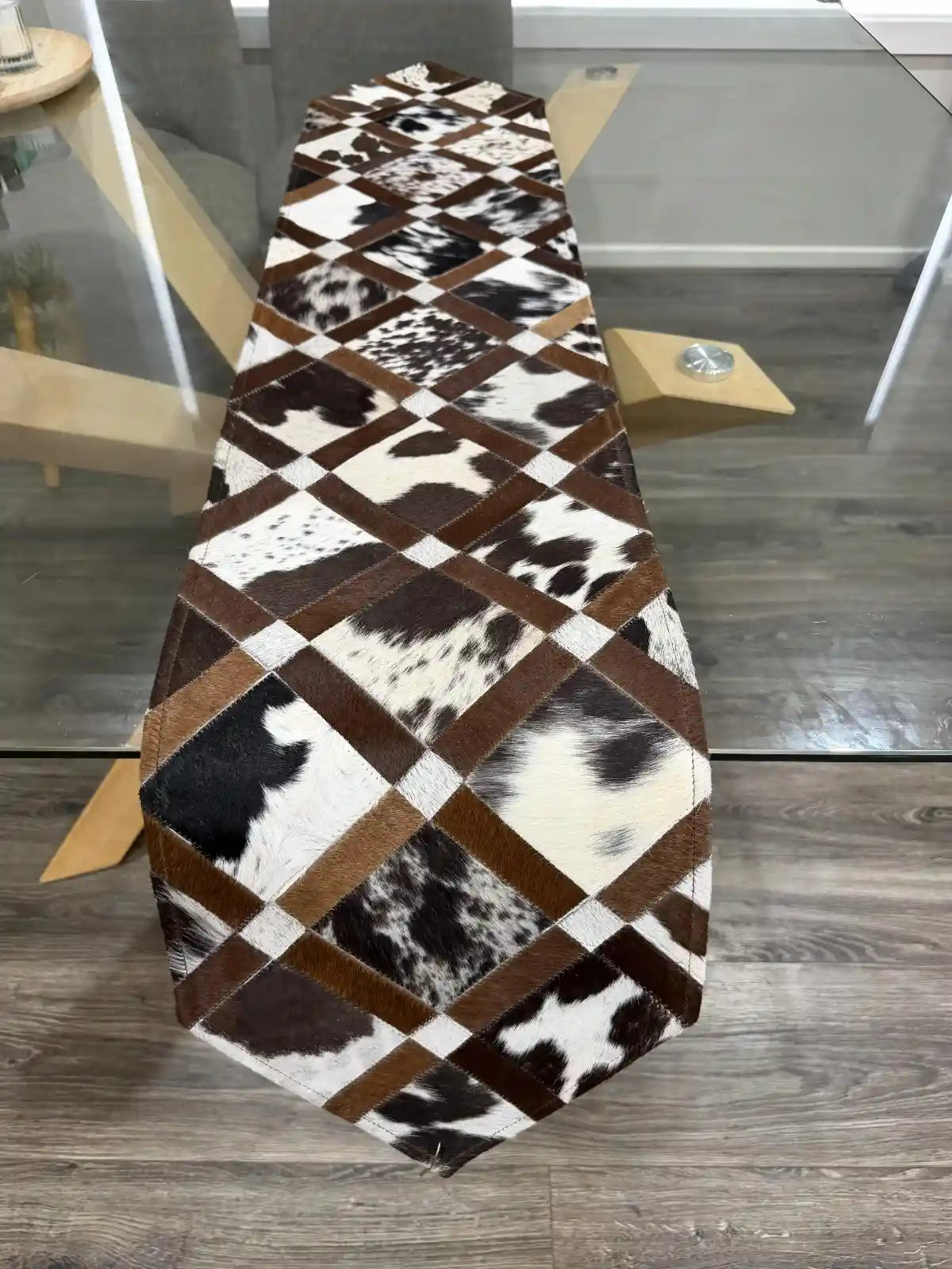 Patchwork cowhide rug on a wooden floor
