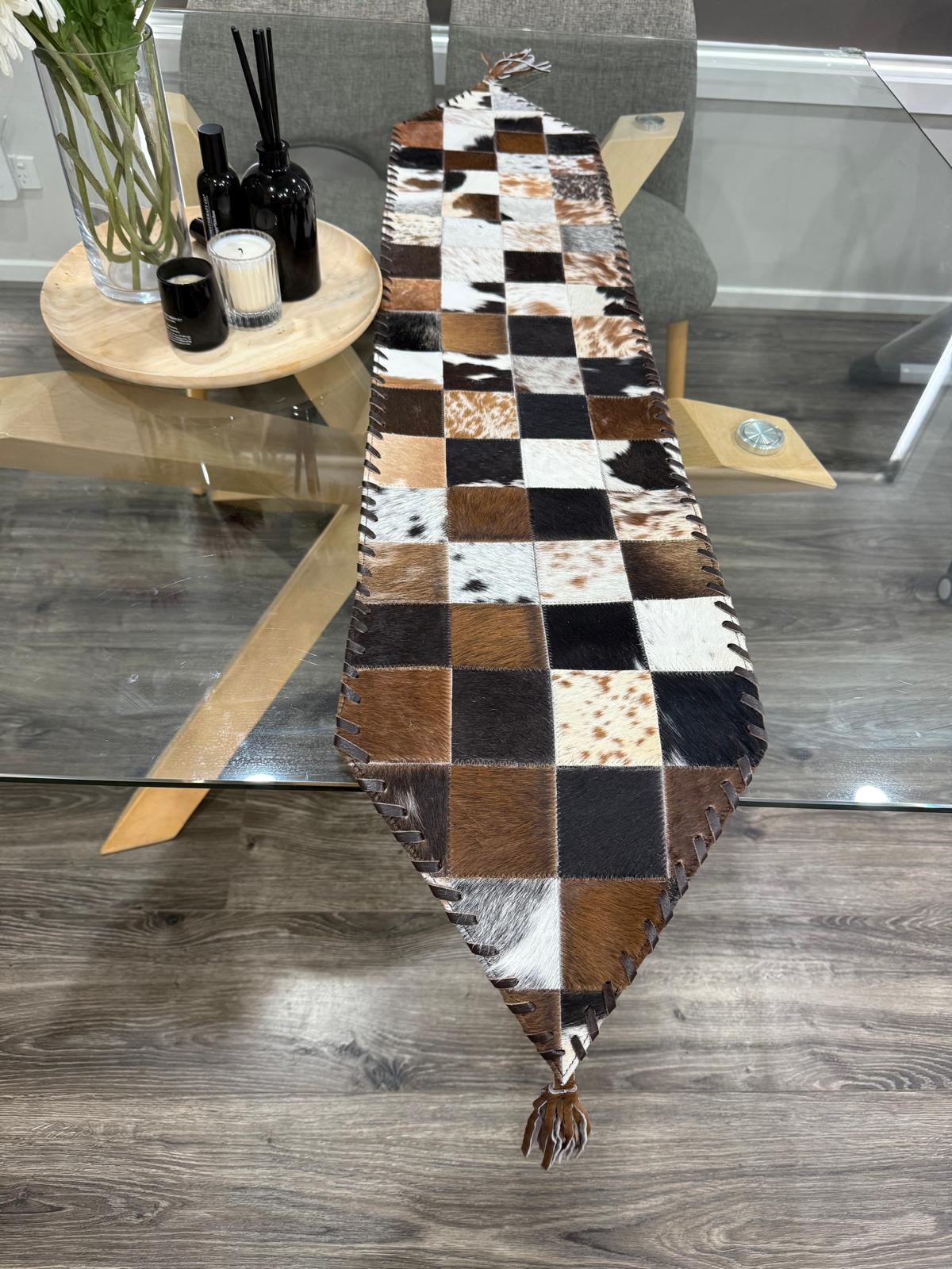 Patchwork cowhide table runner on a glass dining table