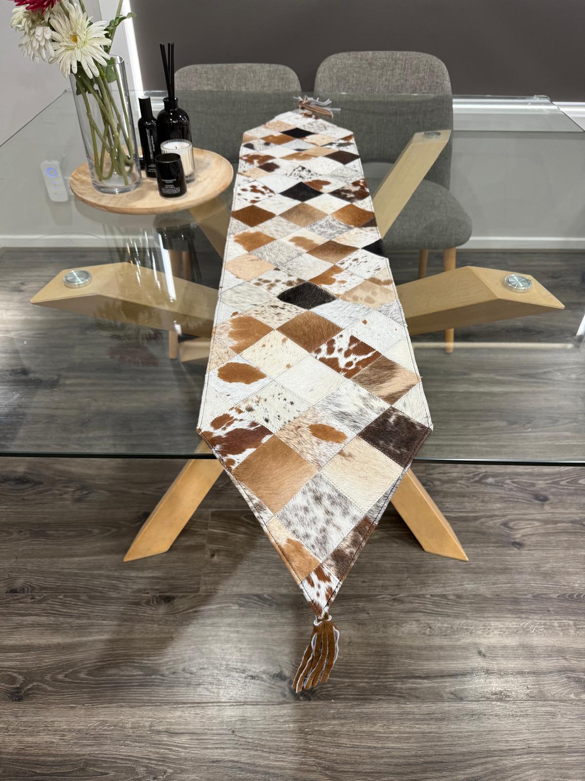 Dining table with a cowhide pattern runner in a modern dining room setting.