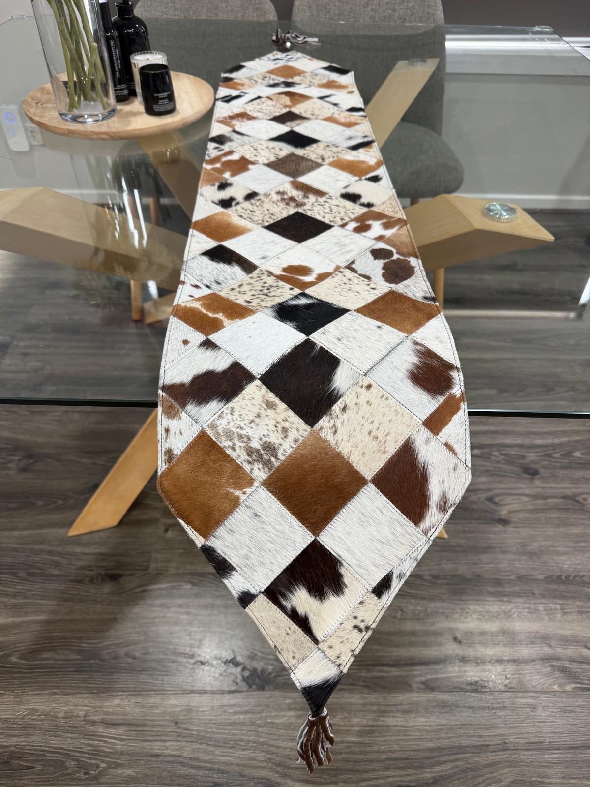 Patchwork cowhide table runner on a wooden table