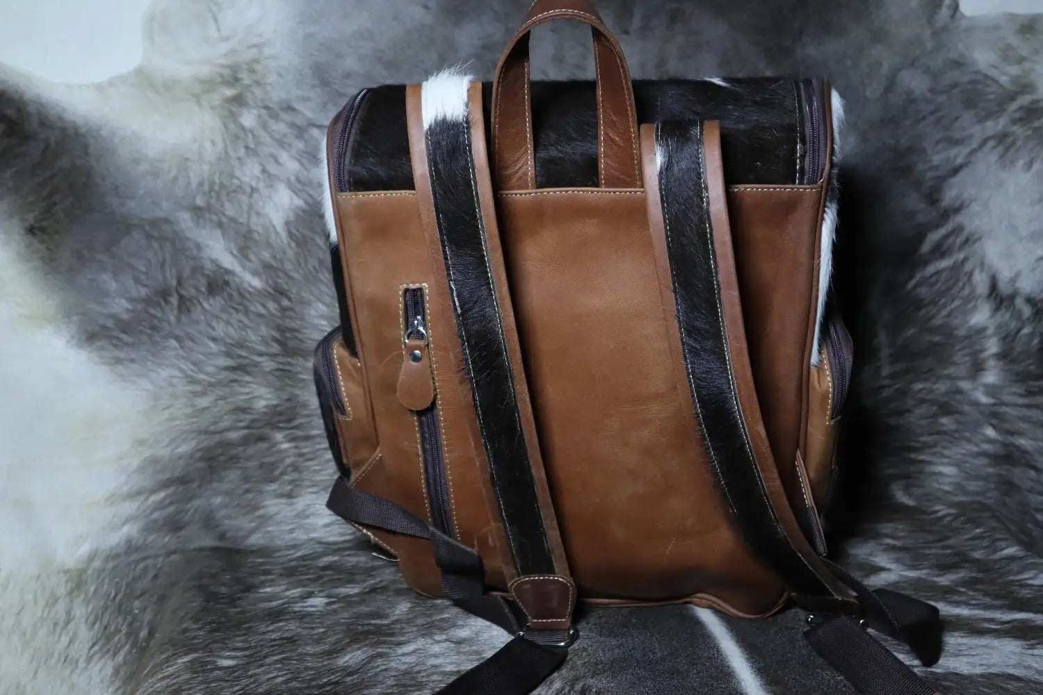 Brown leather backpack on a textured surface