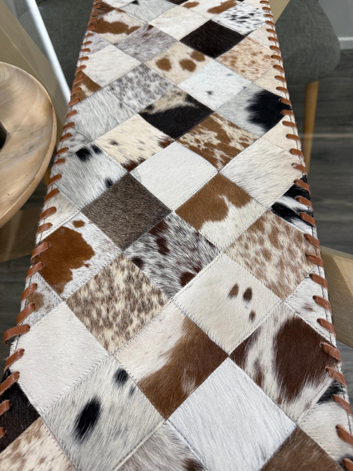 Patchwork cowhide table runner on a dining table