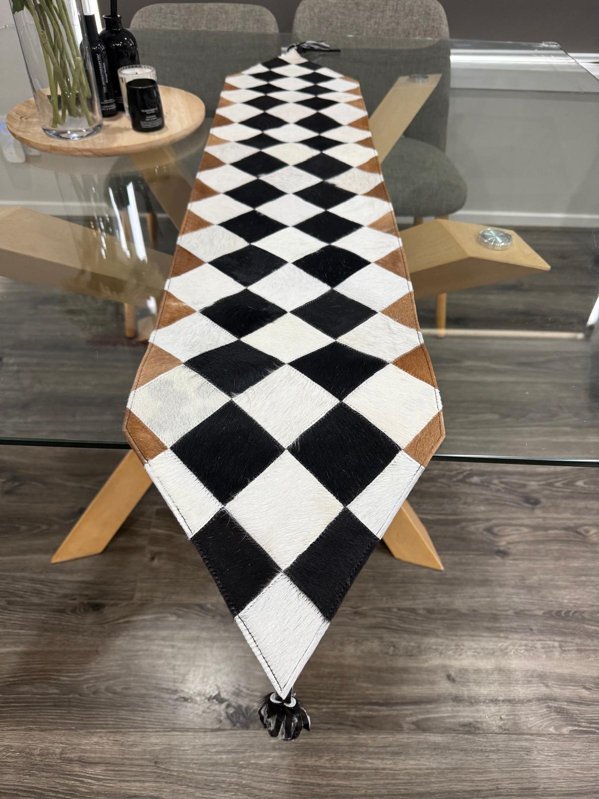 Checkered table runner on a glass table with chairs in a room setting
