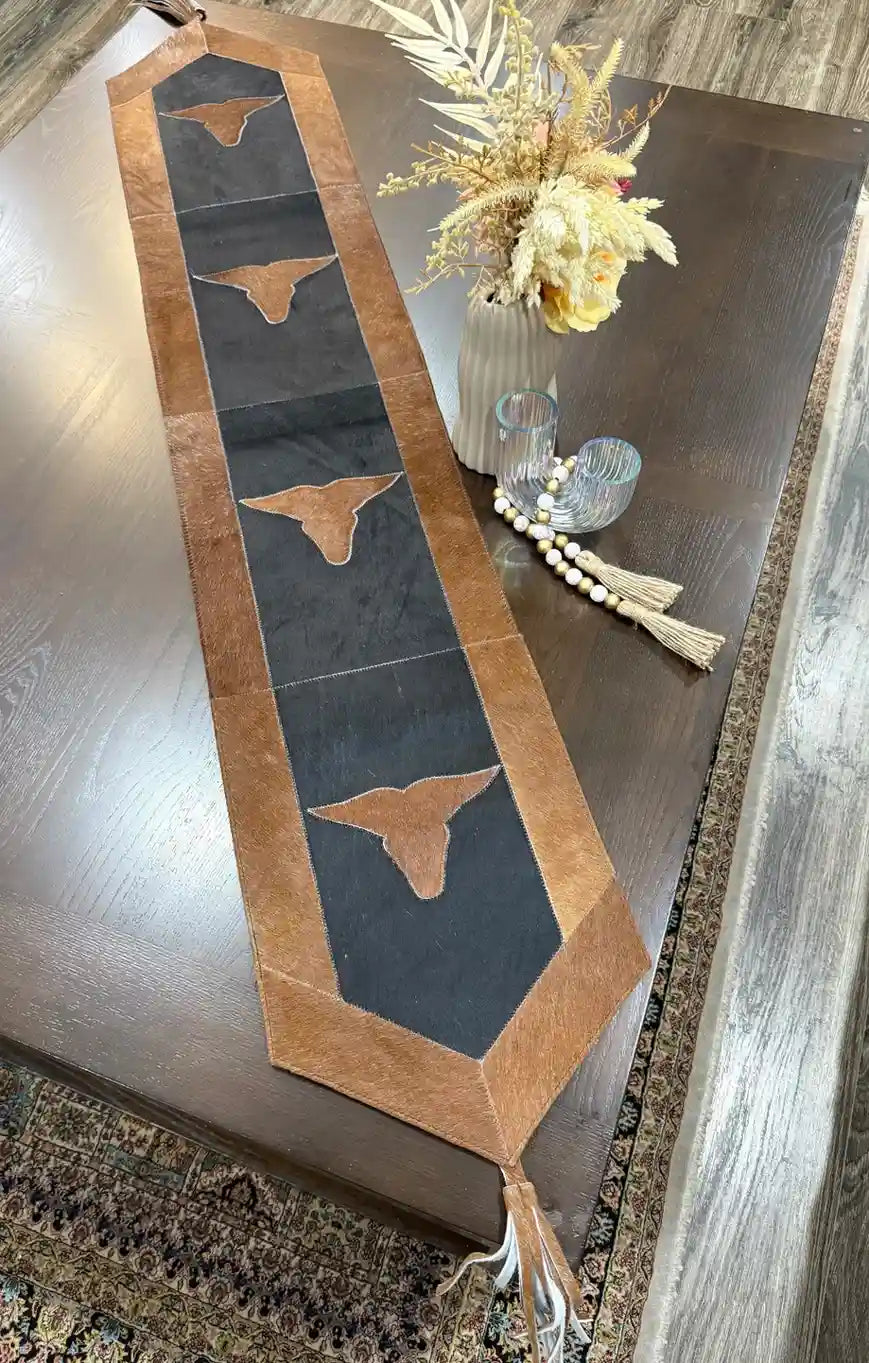 Cowhide bullhead table runner with bullhead patch, having leather fringes