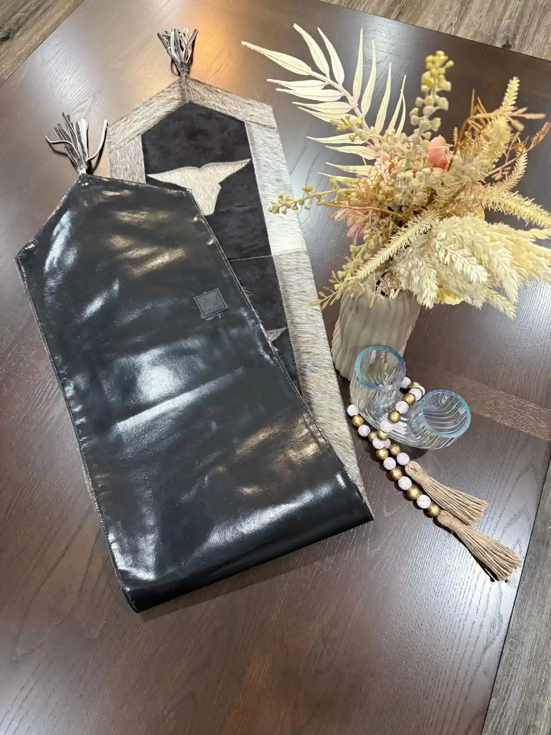 Cowhide bullhead table runner with bullhead patch, having leather fringes