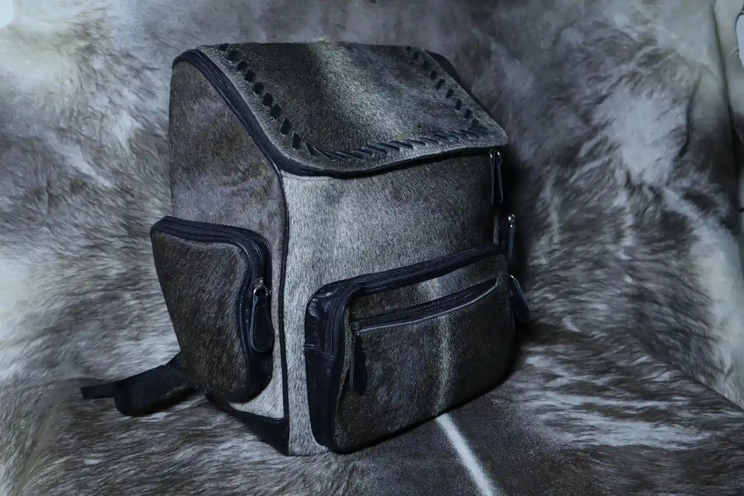 Gray backpack on a textured gray surface